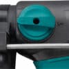 Close-up of a teal dial with an arrow on a black drilling hammer, positioned above a metal rod.