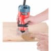 A person uses a 510W bending milling machine to carve a circle on wood.